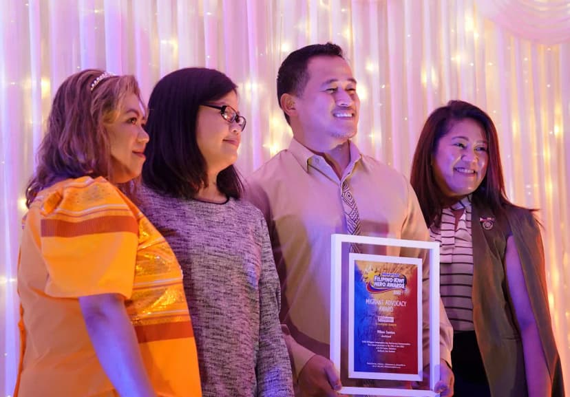 OrbitRemit employees and partners receiving Migrant Advocacy Award together on a stage.